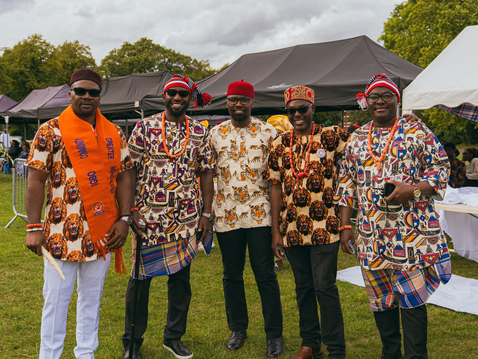 Five men in traditional dress and caps